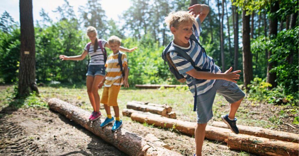 kids balancing on a log in the forest learning the signs you need braces